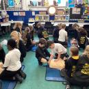 Children practicing performing CPR