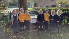 Class 1 making a hedgehog home in the garden.
