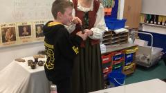 History to life visitor showing a child a historical artefact 
