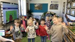 Children in a classroom wearing clothes with spots on