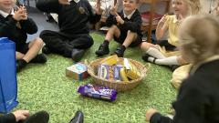 Children sat round a basket of food