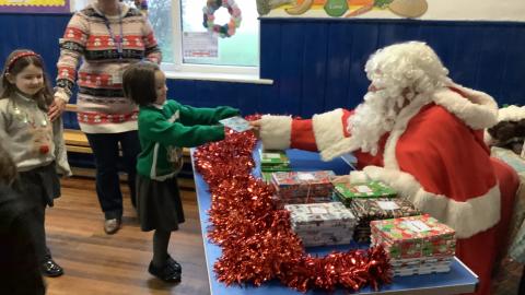 Father Christmas giving a present to a child