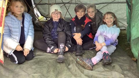 A group of class 3 children sat inside their den