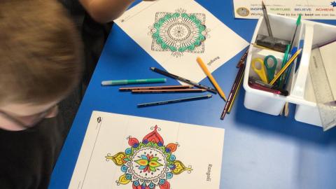 Class 3 children doing mindful rangoli pattern colouring