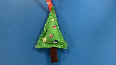 A hand sewn felt Christmas tree decoration sewn by a class 3 child