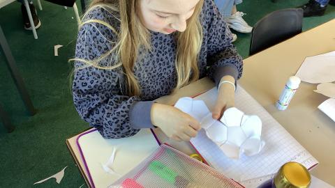 Girl making 3D shapes with paper