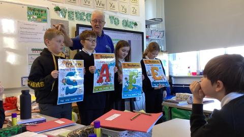 Children holding up water safety posters 