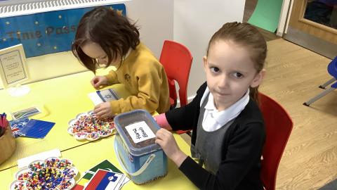 Children making flags with hamma beads