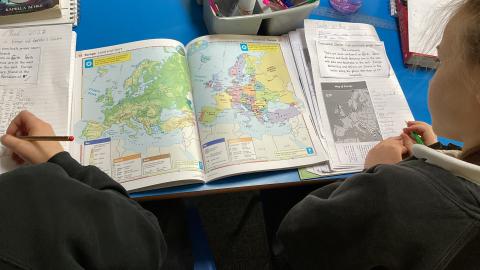 Class 3 children looking at Europe in an atlas