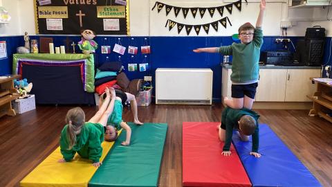 Class 3 children in pe doing gymnastics balances