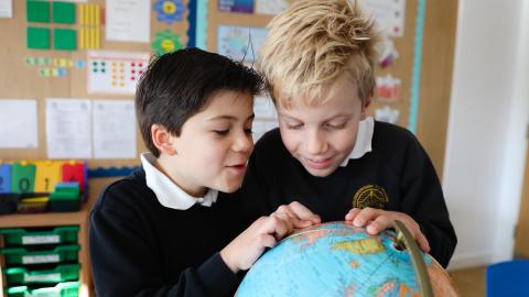Pupils looking at a globe