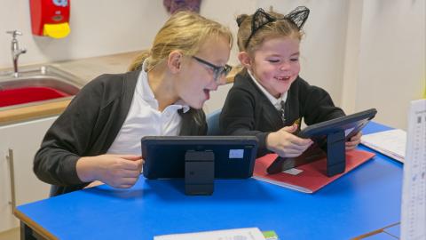 Children learning on iPads