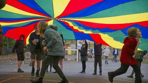 Children at playtime under the parachute