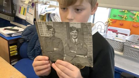 Boy holding WW2 soldier photo