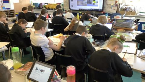 children sitting at desks in class