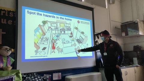 Fire Safety office showing a powerpoint slide about hazards in the home