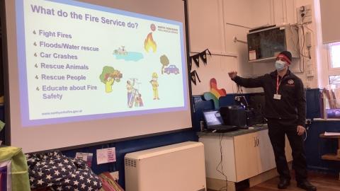 Fire Safety office showing a powerpoint slide about what the fire brigade does
