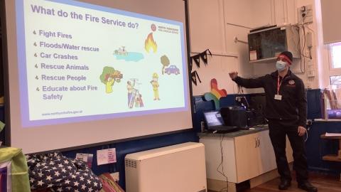Fire Safety office showing a powerpoint slide about what the fire brigade does