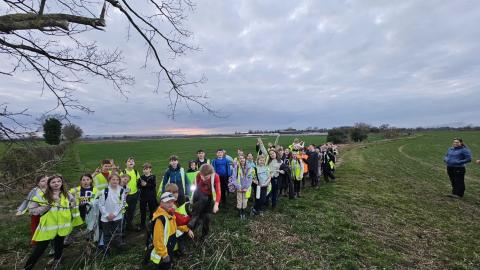 The whole group on the night walk with the sun setting behind them.