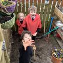 3 children digging in mud