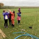 A group of girls working together to build the structure of their den
