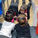 Children using now press play laying down at the start of the story
