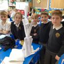 Stem challenge children with paper structures supporting an apple to replicate a skeleton