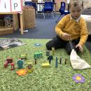 Boy playing with small world 