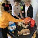 3 children making bird feeders