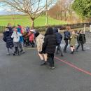 Class 3 pupils acting out the properties of a liquid moving closely together 