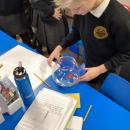 A child observing their sweet in water for an experiment