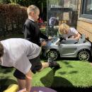Children cleaning toy car