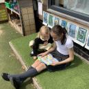 Year 6 buddy reading to reception child 