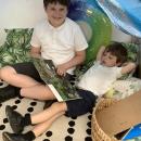 Sharing a book with their buddy 