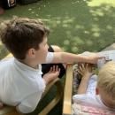 year 6 buddy supporting reading with reception child 