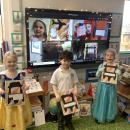 Children holding pictures in classroom