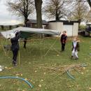 Children putting a roof on their den structure