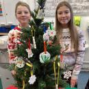 Children presenting their entries gifts on a tree