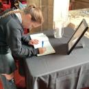 Child signing the book of condolence 