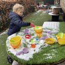 Child putting snow in buckets
