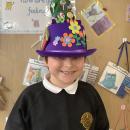 A child wearing an easter bonnet decorated with chocolate