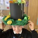 A child wearing an easter bonnet decorated with eggs and chicks