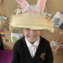 A child wearing an easter bonnet decorated with a bunny