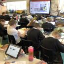 children sitting at desks in class